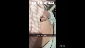 Cute girl edging with a full bladder makes a big mess all over her bed